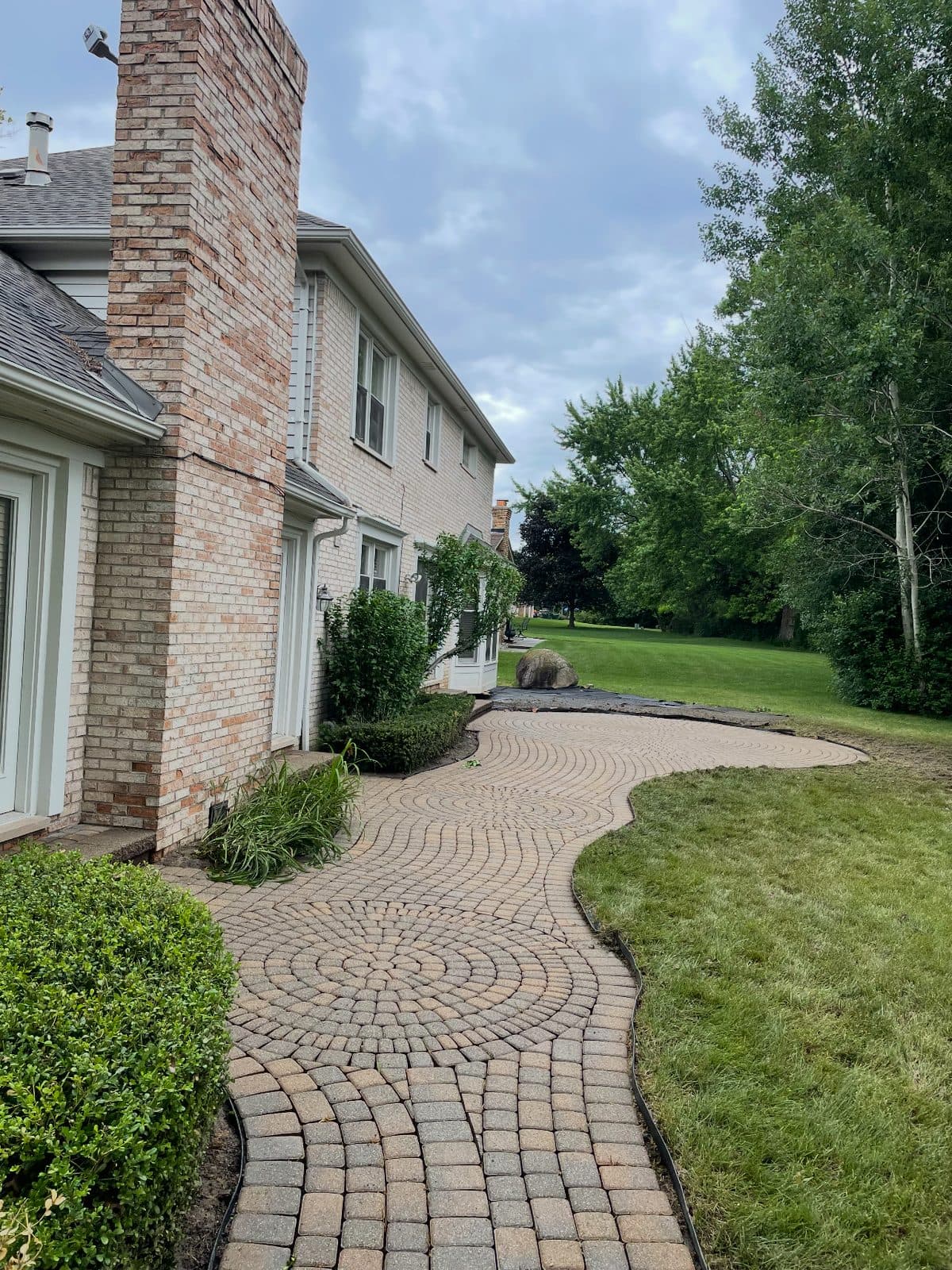 Cleaned cobblestone walkway and tidy beds in Troy